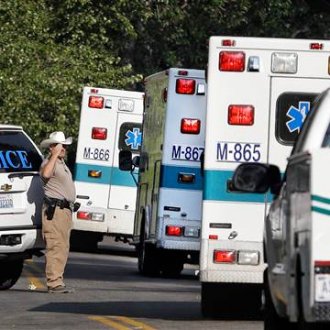 Image: Twisp Police Chief Paul Budrow salutes as ambulances carry the bodies of three firefighters