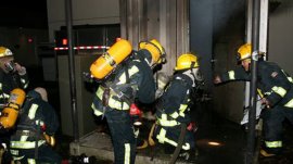 Surrey Fire Service volunteer firefighters performing an exercise exercise.