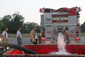 Volunteer Fire Chief Harold Rohde (far right) and volunteer firefighter Jacob Coon, at a fire education exercise during the Enders Fire Company in Berryville, Virginia.