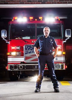 volunteer in front of Karns fire truck